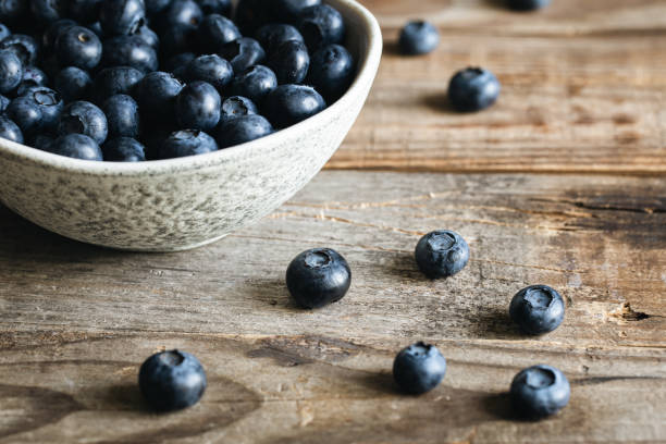 istock Bowl with blueberries on a wooden background, close up. 1536485518