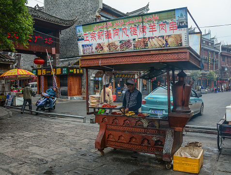 Hunan, China - Nov 5, 2015. Vendors walking on street at Fenghuang Ancient Town in Hunan, China.