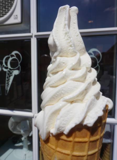 Soft ice cream. Soft white vanilla ice cream. Soft ice cream in a cone. White ice cream in a waffle cone.