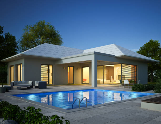 istock Modern white bungalow with pool in the evening 1536512324