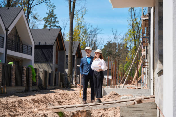 istock Smiling engineer and head architect enjoying builded houses at construction site 1536513821