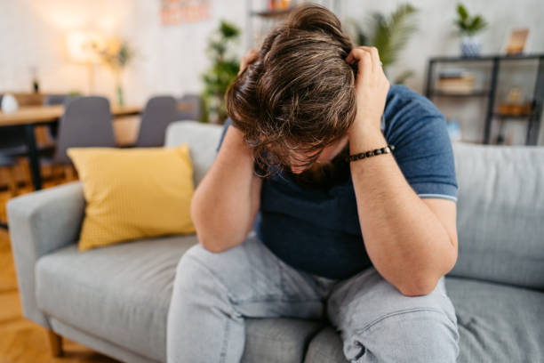 istock Sad Young Man Sitting At Home On The Sofa 1536518155