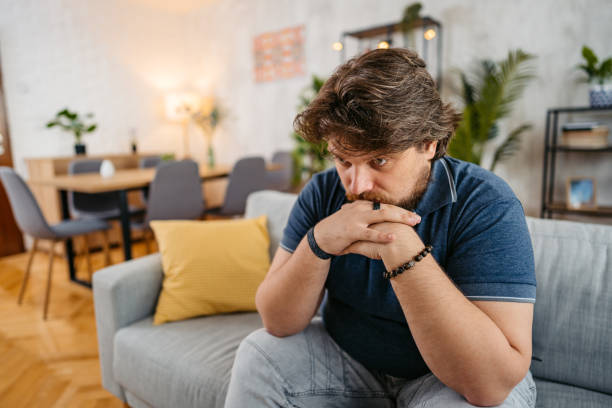 istock Sad Young Man Sitting At Home On The Sofa 1536519215
