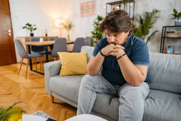 istock Sad Young Man Sitting At Home On The Sofa 1536528286