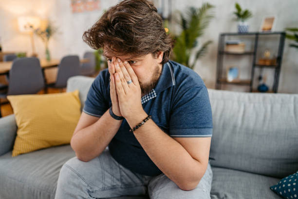 istock Sad Young Man Sitting At Home On The Sofa 1536529938