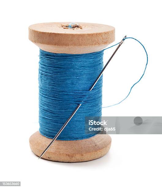 A Spool Of Blue Thread With A Needle In It Stock Photo - Download Image Now - Thread - Sewing Item, Sewing Needle, Spool