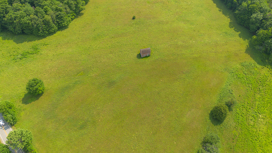 Old small abandoned house in the middle of a field in the Canadian countryside in Quebec