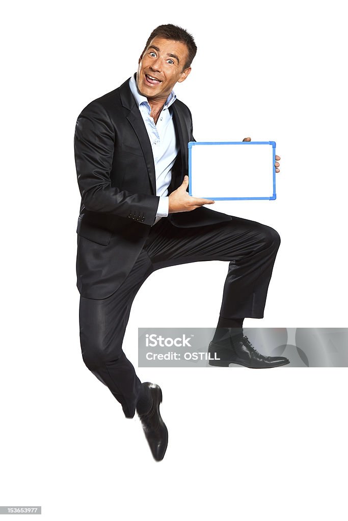 Un salto de hombre de negocios mostrar sosteniendo pizarra acrílica - Foto de stock de Adulto libre de derechos