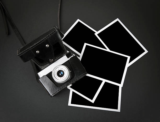 istock Old camera and photo papers 153655260