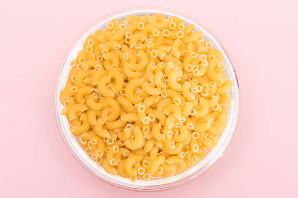 istock Uncooked Chifferi Rigati Pasta in Glass Jar on Pink Background 1536562844