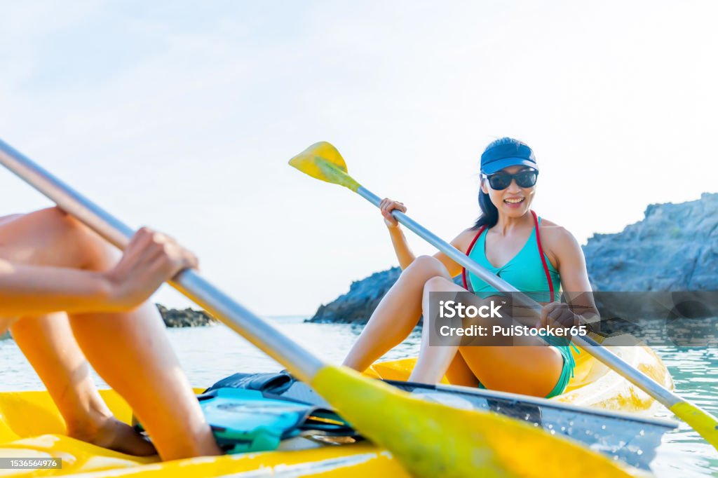 Asian athletic woman together with friend on kayak and take a photo. Outdoor water sport and travel on summer holiday Thailand. Friendship Stock Photo
