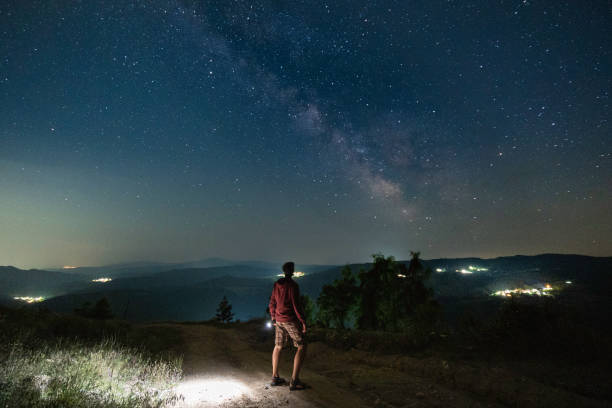 istock Man at night stargazing. Getting away from it all. 1536598535