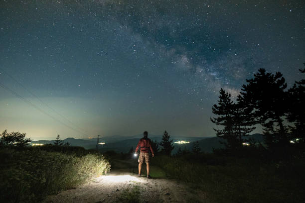 istock Man at night stargazing. Getting away from it all. 1536598539