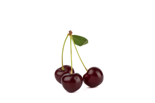 istock Three ripe juicy cherries with a leaf isolated on a white background. 1536603427
