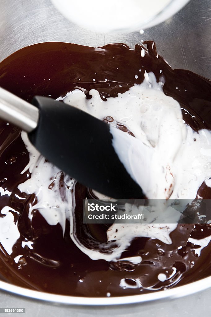 Mix chocolate and milk mixing melted dark chocolate with cream cooking a chocolate mousse Chocolate Mousse Stock Photo