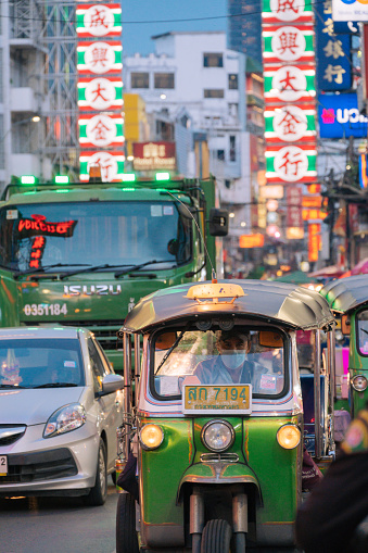 Bangkok, Thailand - June 20, 2023: Tuk tuk is a famous public transportation in Chinatown, Bangkok, Thailand.