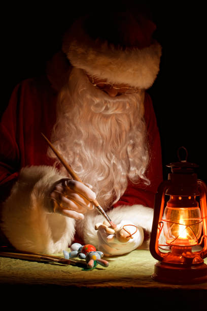 istock Santa Claus painting a toy 153664522