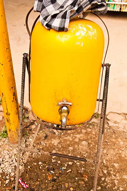Faucet is mounted on a yellow bucket.