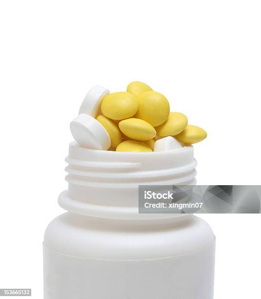 Foto de Overflow Pílulas Em Medicina Garrafa e mais fotos de stock de Alívio - Alívio, Amarelo, Branco
