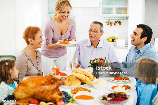 Family At Dinner Table For The Thanksgiving Day Stock Photo - Download Image Now - Domestic Life, Large Family, Child
