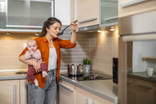 istock Young mother in kitchen with baby 1536672403