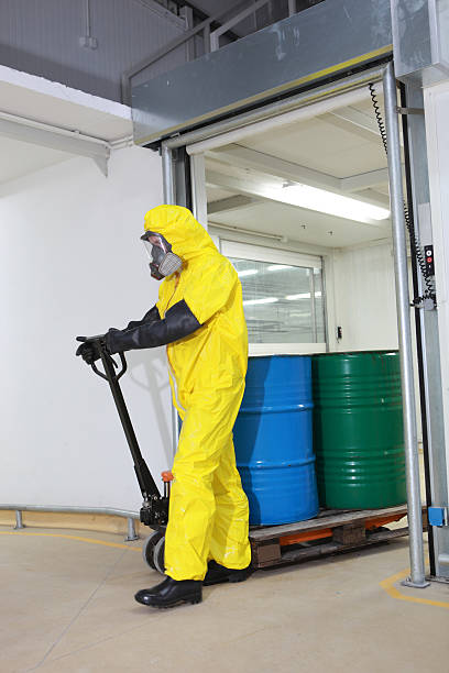 istock technician transport barrels of chemicals on forklift 153667740