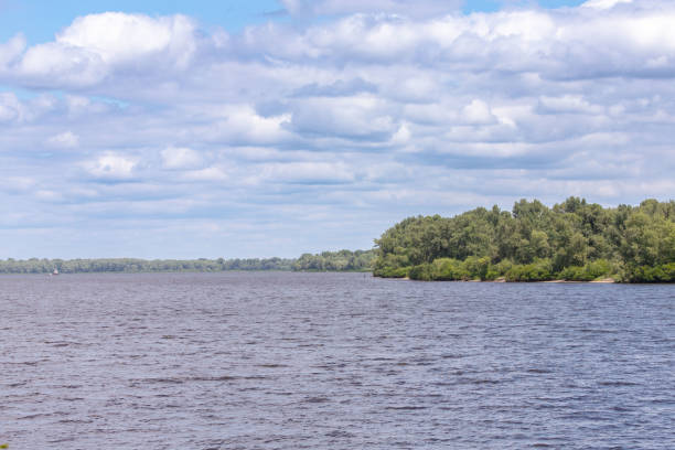 River landscape. Blue sky with white clouds. Endless space. Summer weather. The beauty of Ukraine's nature.