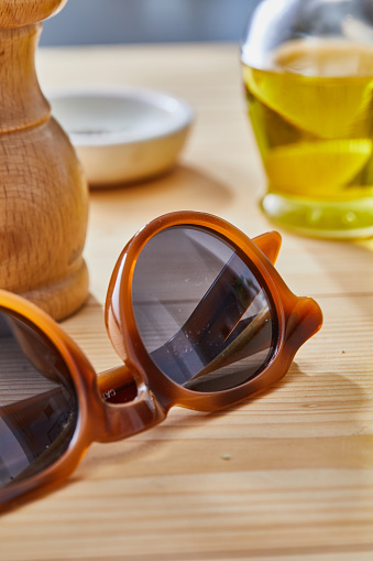 Sunglasses on the wooden table, food preparation, healthy lifestyle, city life, vacation, summer lounge