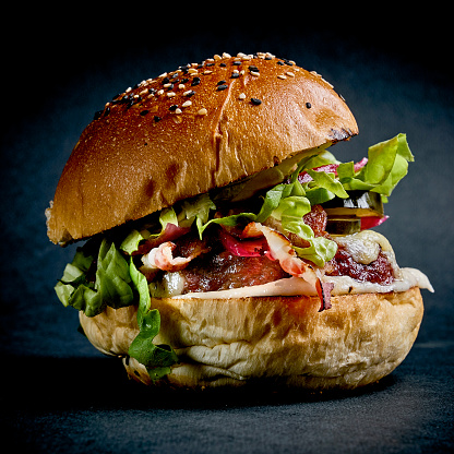 Hamburger with tomato bacon and salad
