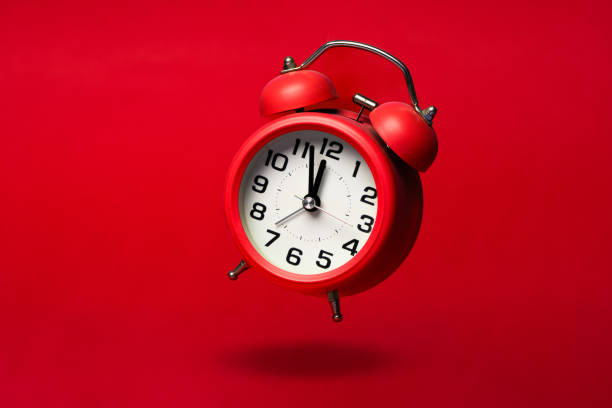 istock Red classic alarm  clock on the red background 1536740107