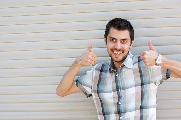 istock Happy smiling young businessman with okay gesture 153674559