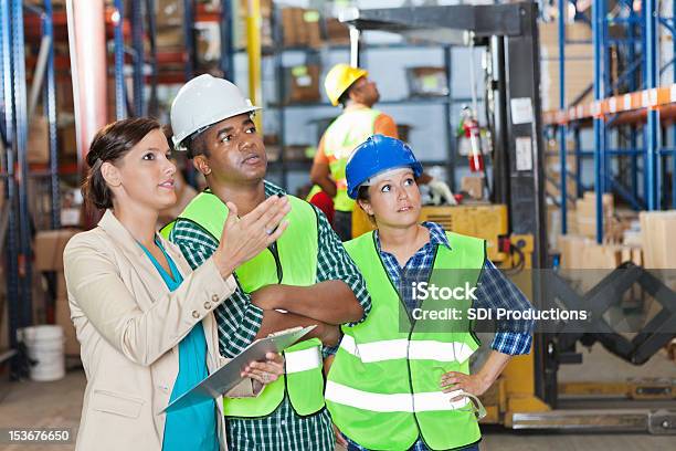 Company Executive Explaining Order To Shipping Distribution Warehouse Workers Stock Photo - Download Image Now