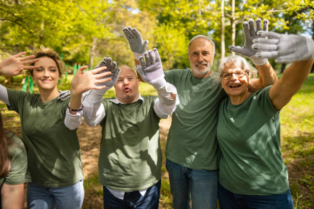 istock Volunteers waving to camera after collecting garbage in a forest 1536768516