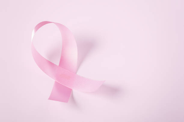istock Breast cancer awareness pink ribbon on light background 1536770079