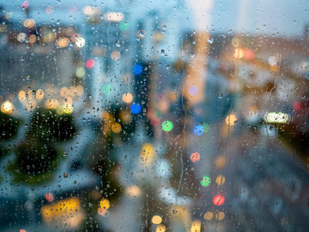 Raindrops on a glass window pane in focus stock photo