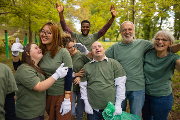 istock Volunteers waving to camera after collecting garbage in a forest 1536784041