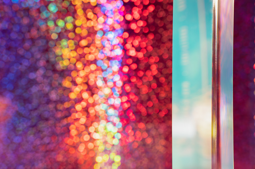 Rainbow sparkle background with prism, bokeh, pink and blue shadows