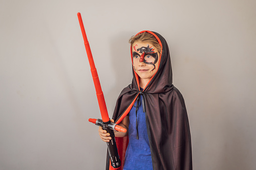 Boy with a picture of a dragon on his face for party or halloween.