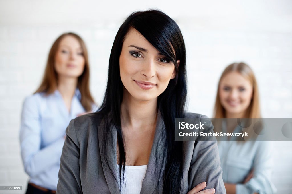 Brunette woman business leader Portrait of three business women. Adult Stock Photo