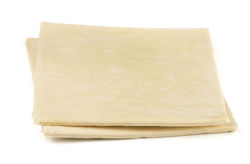 Two sheets of frozen puff pastry isolated on white