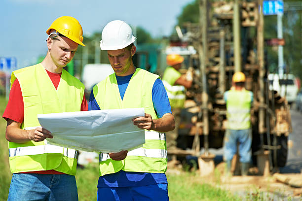 Engineers builders at road works construction site Two engineer site managers builders with blueprint plan at geology roadwork construction site geologist stock pictures, royalty-free photos & images