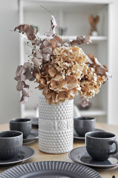 istock Pretty flowers in vase on a dinning table with served dishware 1536825733