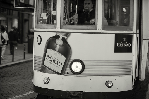 Lisbon, Portugal - January 15, 2023: An old fashioned tram rides along a street in Lisbon downtown.