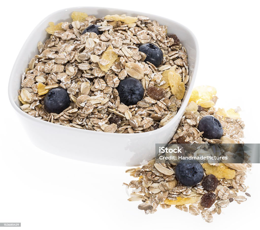 Mixed Muesli in a bowl isolated on white Mixed Muesli in a bowl isolated on white background Berry Fruit Stock Photo