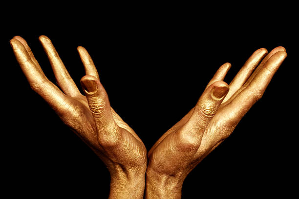 istock Two male hands in gold paint isolated 153685563