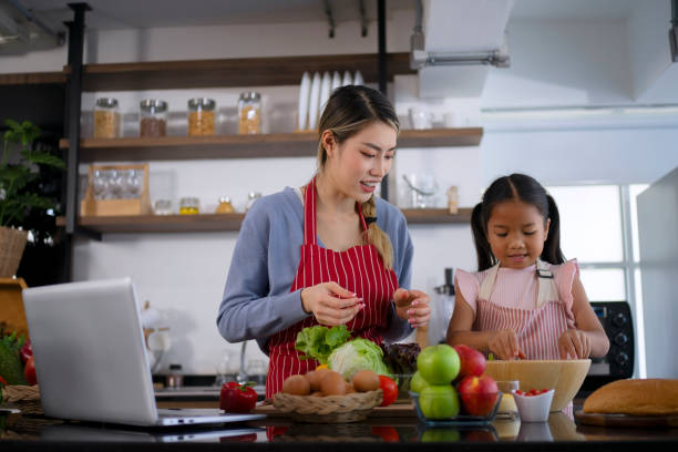 istock Mother and daughter make a meal at kitchen. 1536859828