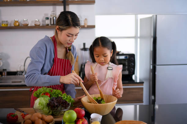 istock Mother and daughter make a meal at kitchen. 1536859839