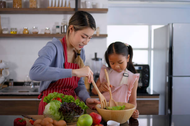 istock Mother and daughter make a meal at kitchen. 1536860047