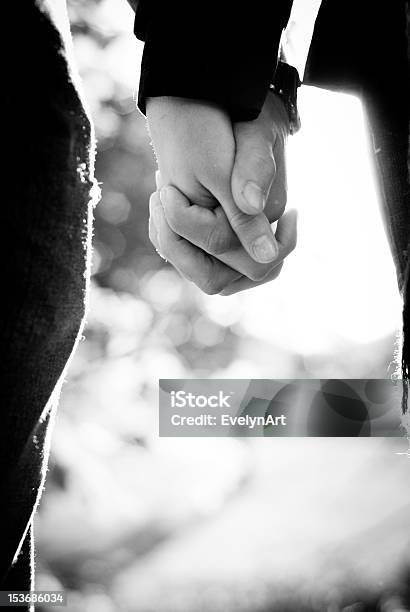 Black And White Picture Of Two People Holding Hands Stock Photo - Download Image Now
