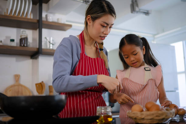 istock Mother and daughter make a meal at kitchen. 1536860961
